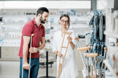 man and woman looking at crutches