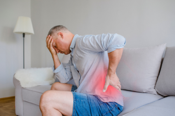man at home with back pain