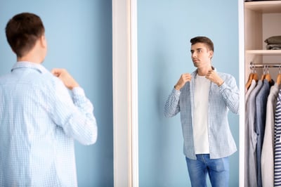 man dressing in mirror