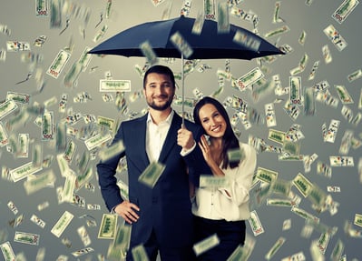 man and woman standing under an umbrella, with dollar bills raining down, symbolizing the idea that taller people tend to earn more money