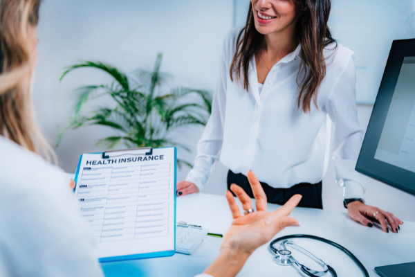 woman filling out health insurance form